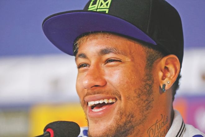 Brazil superstar Neymar is all smiles during a news conference in Teresopolis near Rio de Janeiro on Wednesday. The World Cup hosts take on Colombia in the second quarterfinal at the Estadio Castelao in Fortaleza today. PHOTO: REUTERS