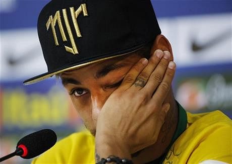Brazil's Neymar wipes a tear during a press conference at the Granja Comary training center in Teresopolis, Brazil, Thursday, July 10, 2014. The Brazilian soccer star is back on his feet after suffering a broken vertebrae during a World Cup soccer match against Colombia. Brazil will be disputing a third place finish, without its star on Saturday. Photo; AP