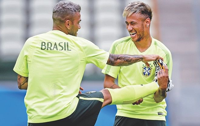 Though Brazil's place in the round of 16 is not confirmed as yet, their stars Neymar (R) and Dani Alves appeared relaxed in their training session in Fortaleza. PHOTO: GETTY IMAGES