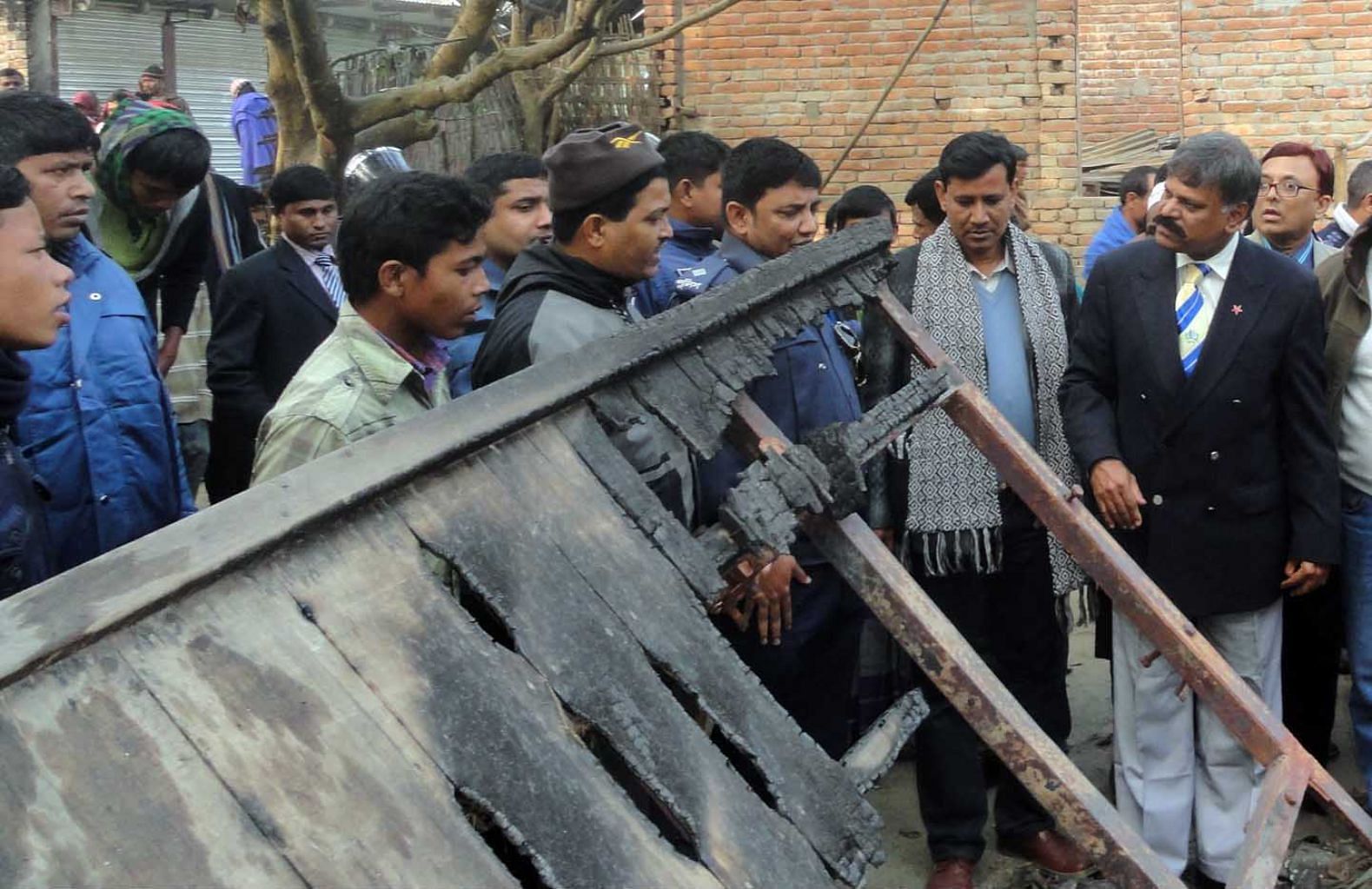 National Human Rights Commission chief Mizanur Rahman, right, visits Kornai of Dinajpur yesterday to see the atrocities on the Hindus committed right after the January 5 polls. Photo: Star