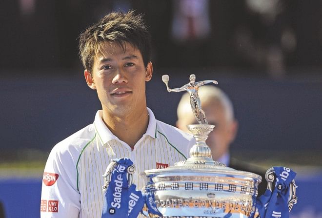 Kei Nishikori shows off his Barcelona Open trophy. PHOTO: AFP