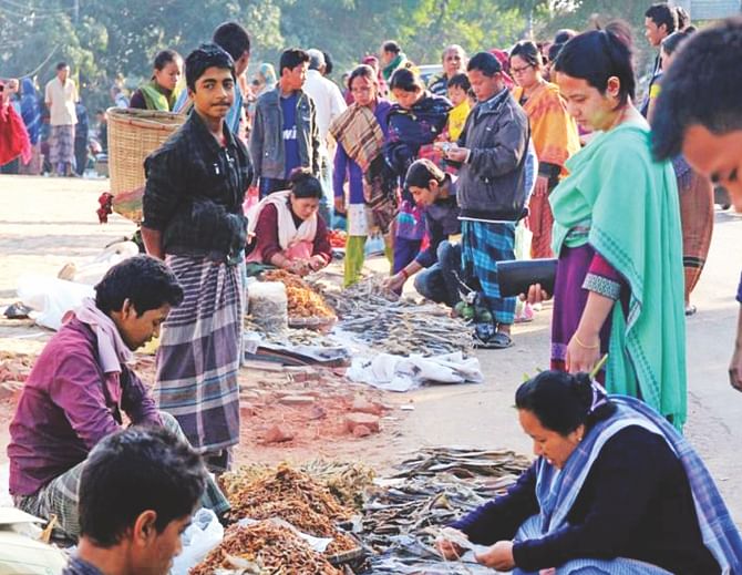 Only a handful of people are seen at a weekly market in College Gate area of Rangamati yesterday. It usually teems with people buying and selling goods. Photo: Star
