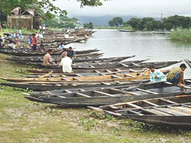 Traditional country boats are kept in line for sale at noukar haat (boat market) at Kawrakandi Bazar in Tahirpur upazila of Sunamganj. Boats are brought to the market, which sits twice a week, hours before it opens.  Photo: Star