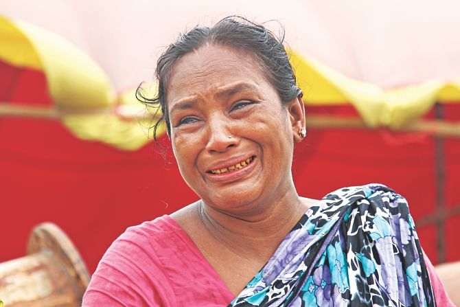 Rekha, a resident of Faridpur, bursts into tears at Mawa terminal on the bank of the Padma as seven members of her family remain missing in the Pinak-6 disaster.   Photo: Sk Enamul Haq 