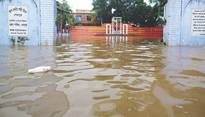 The Shaheed Minar at Sherpur town is water-logged after incessant overnight rain yesterday.  Photo: Banglar Chokh