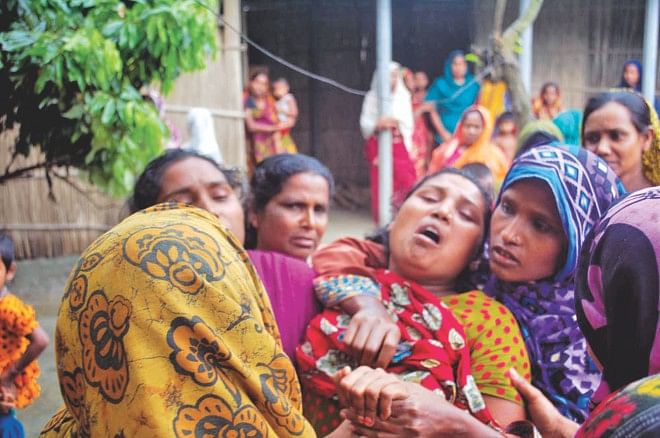Relatives of deceased Sultan Mahmud mourn after his body was taken to his home in Pabna.  Photo: Star