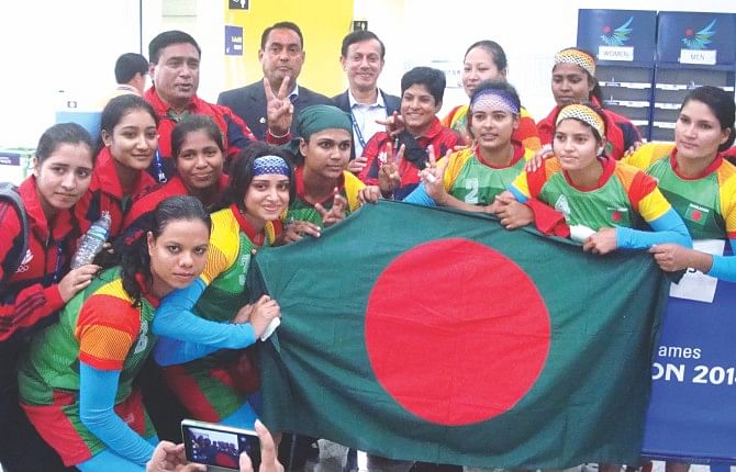 Bangladesh women's kabaddi team members show the national flag after they beat South Korea in the Asian Games at the Songdo Global University Gymnasium in Incheon yesterday. PHOTO:  ANISUR RAHMAN