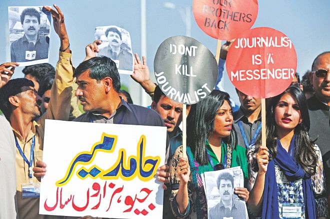 Pakistani journalists hold placards during a protest against the attack on Geo television journalist Hamid Mir by gunmen in Islamabad, yesterday.  Photo: AFP