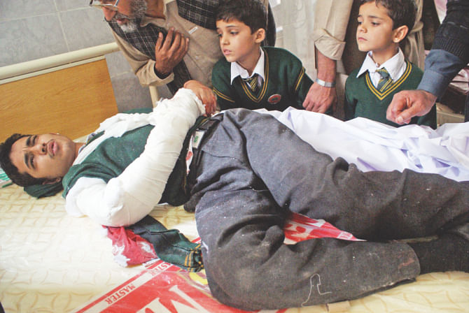 An injured student lies on a bed at a hospital following the attack. Photo: AFP