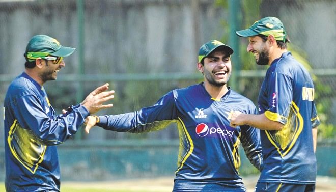 Pakistan's two main batting forces, Shahid Afridi (R) and Umar Akmal (C), are in jovial mood as they joke with left-arm spinner Abdur Rehman during practice at the Academy Ground in Mirpur yesterday. They will however be down to the serious business of retaining their Asia Cup title when they take on Sri Lanka in the final today.  PHOTO: Firoz Ahmed