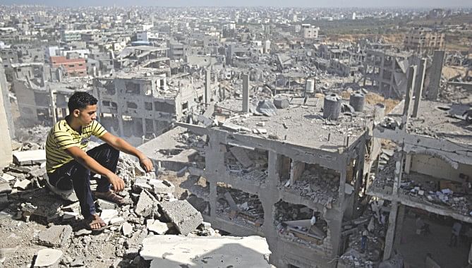 Palestinian man looks out over destruction in part of Gaza City's al-Tufah neighbourhood yesterday. Photo: AFP