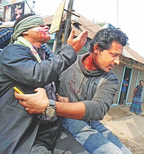Two people rush to hospital on a rickshaw after they were shot by police in Chaumohani of Noakhali yesterday. The firing took place when BNP-Jamaat men went on the rampage there. Photo: Banglar Chokh