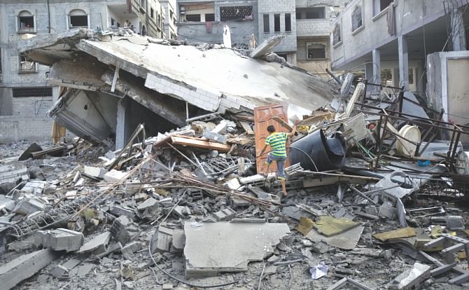 A Palestinian climbs through the rubble of a house after they were hit in Israeli air strikes in Gaza City yesterday. Violence reverberated across Gaza with four Palestinians killed in Israeli air strikes as Egypt proposed a new ceasefire that would open key crossings into the blockaded territory. Photo: AFP