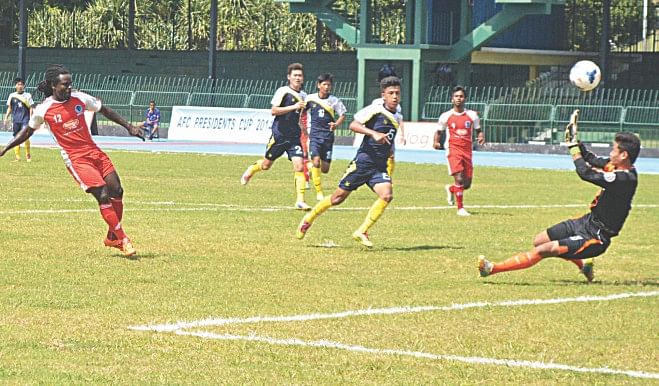 Sheikh Russel KC forward Pascal Millien (L) dinks one over the Ugyen Academy goalkeeper during their 4-0 victory in the Group A fixture of AFC President's Cup at the Sugathadasa Stadium in Colombo yesterday.  PHOTO: COURTESY