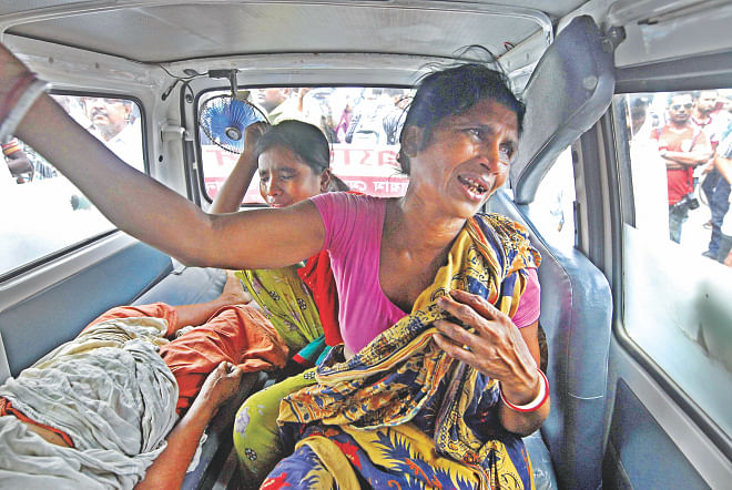 Relatives of a stroke-hit patient are in tears as they sit helpless in an ambulance in front of Dhaka Medical College Hospital around 2:00pm yesterday. They were unable to enter the hospital as its gates were locked following a clash between a patient's attendants and intern doctors.   Photo: Courtesy