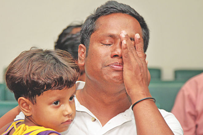 Seeing his daughter after three years, Shafiul could not hold back his tears at the CID office in Malibagh. Shafiul was among the 12 people who returned from Iran yesterday after being held hostage there for months by human traffickers. Photo: Sk Enamul Haq