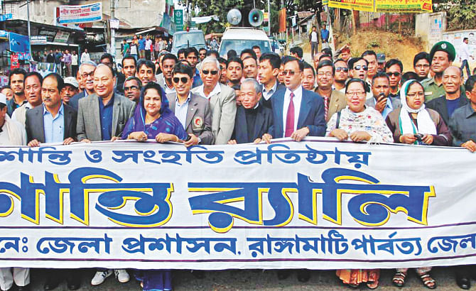 Bangalee settlers and indigenous people yesterday march in a peace procession to defuse the prevailing tension in Rangamati town. Photo: Star 