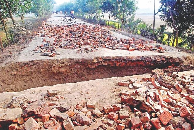 Opposition-called blockade supporters yesterday dug up a trench at Goreya on Gaibandha-Palashbari road, severing road communications between Gaibandha and other districts. Photo: Star