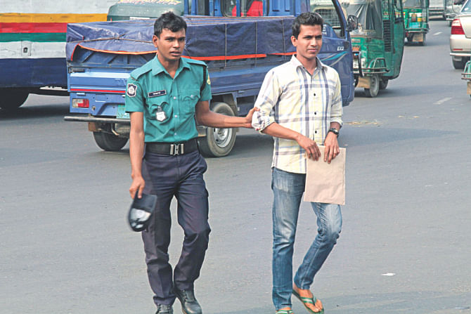 People still jaywalk on Kazi Nazrul Islam Avenue yesterday but only a few got caught by police. Photo: Amran Hossain