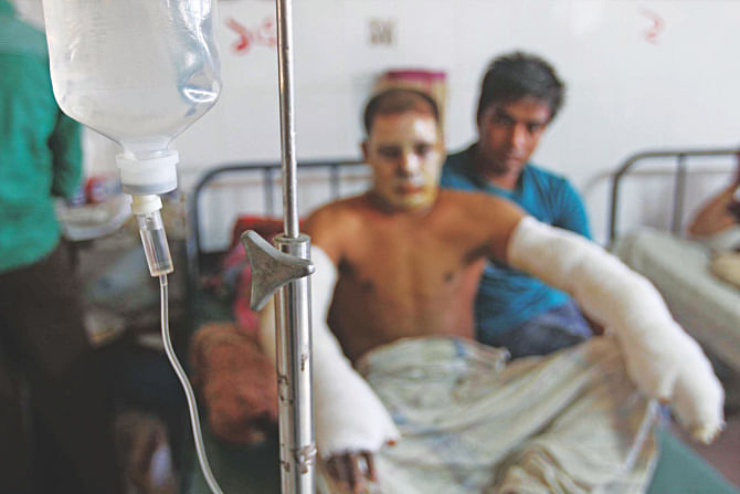 Rickshaw puller Fazlur Rahman at the Chittagong Medical College Hospital yesterday. A petrol bomb was hurled at him in ColonelHat area during the 12th day of the 20-party alliance's blockade. Photo: Anurup Kanti Das