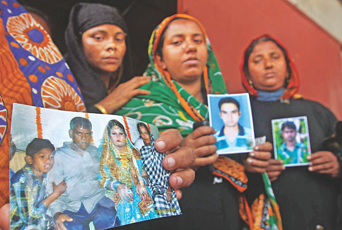 With photos of the missing fishermen, relatives gather at the Majhirghat in Chittagong yesterday hoping for news of their loved ones. MV Bandhan went down in the Bay early Friday with 26 crew members. Photo: Anurup Kanti Das