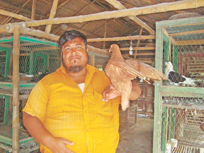 Selim Reza holding a pigeon at his farm. Photo: Star