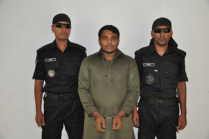 Rapid Action Battalion members produce Omar Farroque Limon (C), son of the owner of the launch Pinak-6 that capsized in #Padma, before journalists after arresting him in Khilkhet area, Dhaka early Friday. Photo: Press release