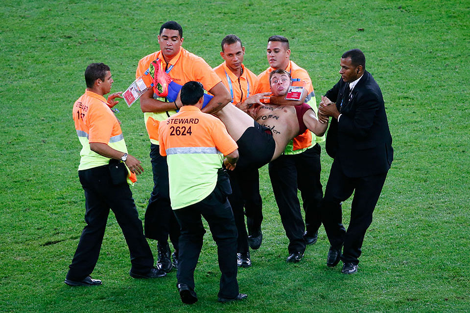 Security personnel carry a pitch invader off the field during the 2014 FIFA World Cup Brazil Final match between Germany and Argentina at Maracana on July 13, 2014 in Rio de Janeiro, Brazil. Photo: Getty Images