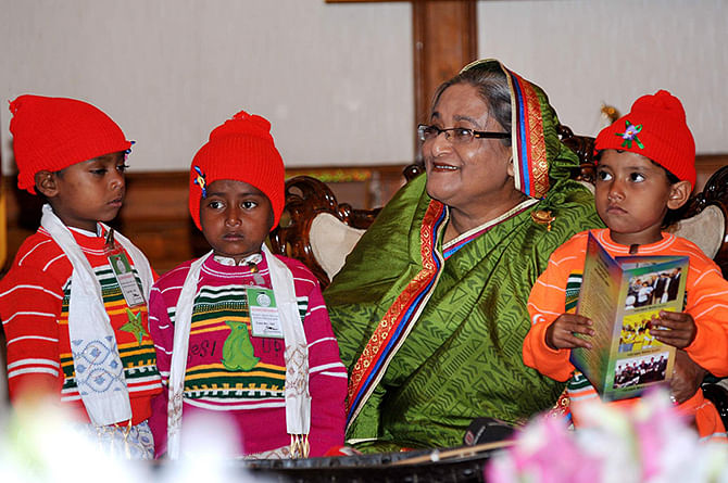 This file photo shows Prime Minister Sheikh Hasina spends her time with children at her official residence Gono Bhaban in the capital. 