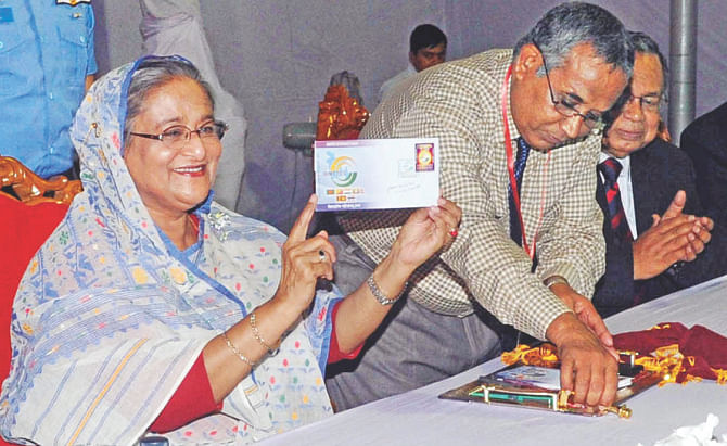 Hasina holding the Bimstec stamp.  Photo: BSS