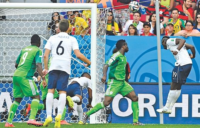 France midfielder Paul Pogba (R) heads in the first goal against Nigeria in the 79th minute of their World Cup round of 16 game at the Mane Garrincha National Stadium in Brasilia on Monday. Photo: REUTERS