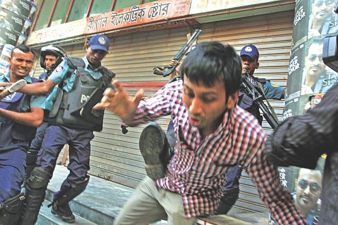 Police beat up Jagannath University students who went to retrieve a dormitory, allegedly occupied by Awami League leader Haji Mohammad Selim, at Patuatuli in Old Dhaka yesterday. Photo: Palash Khan