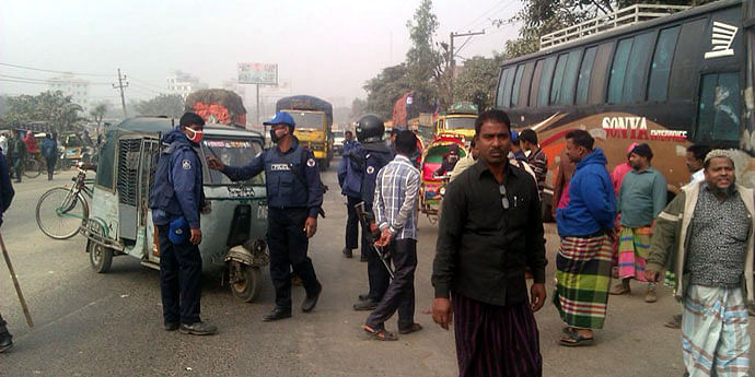 Police personnel check vehicles at Amin Bazar in Savar, an entry point of Dhaka, Sunday morning so that 'unexpected persons' cannot sneak into the capital defying security barriers