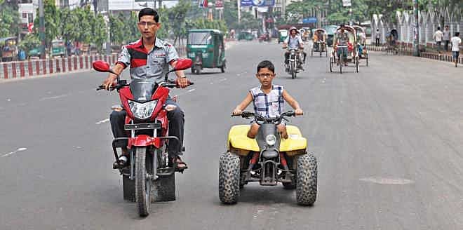 Sometimes empty streets during hartal allow us to enjoy fun ride like this father and the son. Photo: Anurup Kanti Das