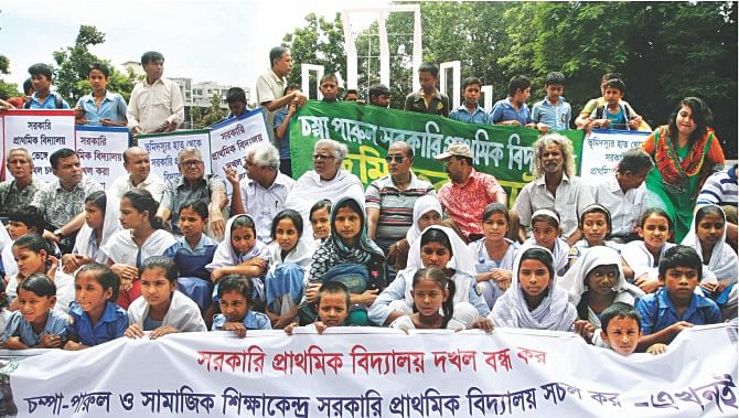 Primary school students, their parents, and civil society members at a rally in front of Central Shaheed Minar in the capital yesterday demand that the government take immediate steps to reclaim the grabbed lands of 28 state-run primary schools in Dhaka city, and resume operations of Champa Parul and Samajik Shikkhakendra schools, buildings of which were demolished. Photo: Star