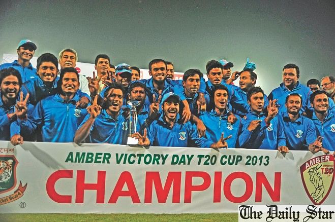 Players and officials of Prime Bank Cricket Club rejoice with the Victory Day T20 Cup trophy after they beat United Commercial Bank BCB XI in the final at Mirpur's Sher-e-Bangla National Stadium on Tuesday. PHOTO: STAR