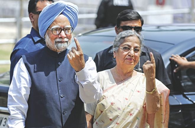 Indian Prime Minister Manmohan Singh holds up his ink-marked finger as he poses alongside his wife for a photograph after casting his ballot at a polling station in Guwahati, the capital of the northeastern state of Assam, yesterday.  Photo: AFP