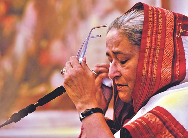 Prime Minister Sheikh Hasina wipes off tears while talking about her life after the August 15, 1975 murder of family members, including Bangabandhu Sheikh Mujibur Rahman. The photo was taken at the Gono Bhaban yesterday at a programme organised to mark her homecoming day. Photo: BSS