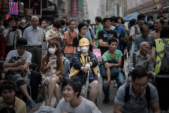 Pro-democracy protesters stand their ground in the Mongkok district of Hong Kong yesterday. Photo: AFP