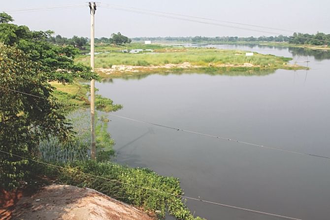 Probashi Polli project, a housing scheme for Bangladeshi expatriates, is seen occupying the Nagda river at Narayankul of Kaliganj in Gazipur. The government has recently made a move to alter the master plan of the capital to help approve 90 acres of land of the proposed project on flood flow zone. Photo: Sk Enamul Haq