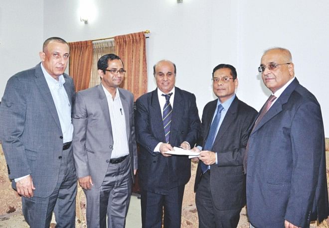 CPD Executive Director Mustafizur Rahman, second from right, hands over a Tk 2,00,000 donation for the Gazans to Palestinian Ambassador Shaher Mohammad at the latter's office in the capital. Photo: Star