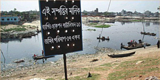 The Star file photo shows the Rapid Action Battalion-10 puts a sign on a channel of the Buriganga in Kamrangirchar, claiming seven acres of land there. Only a year ago, the BIWTA dredged this part of the river and is planning to set up a dock.
