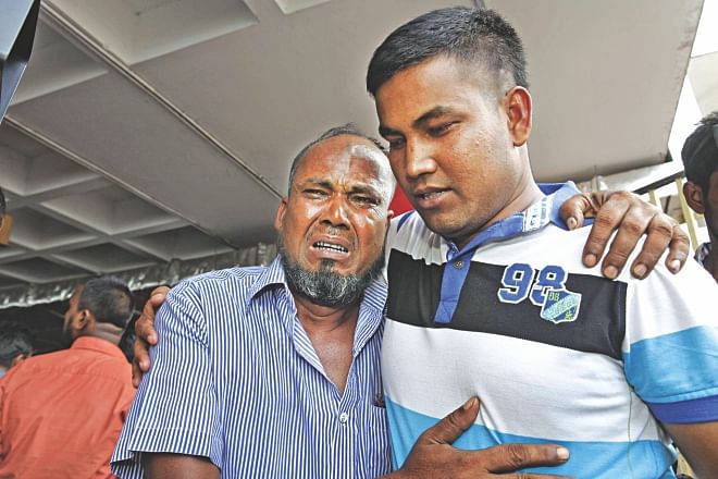 Rasu Sheikh cannot hold back tears seeing his son Selim Sheikh at Shahjalal International Airport in Dhaka yesterday. Selim is one of the 15 Bangladeshis who had been held in captivity for 24 days in conflict-torn Iraq. Photo: Rashed Shumon