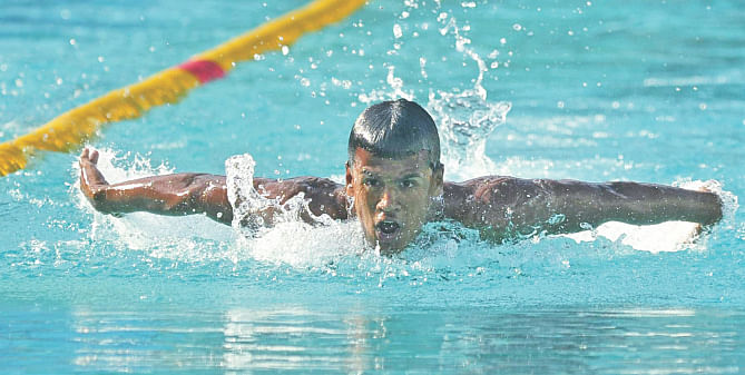 Mohammad Ariful Islam on his way to winning the breaststroke gold, one of the five he won on the second day, of the Cotton Group 30th National Age Level Swimming Competition at the National Swimming Complex in Mirpur yesterday. PHOTO: STAR