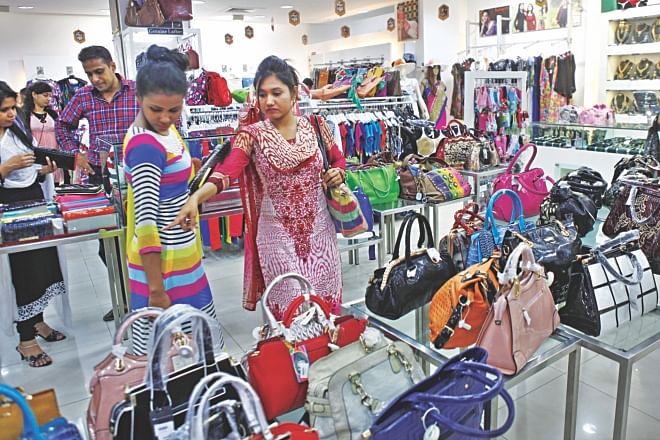Customers take a look at handbags on display at the Infinity Mega Mall at Bashundhara City in Dhaka ahead of Eid festivities. Infinity opened a number of stores across the city to tap the biggest shopping season. Photo: Star