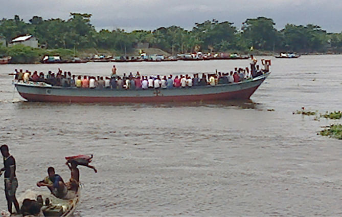 As Eid holidays ended, people from different areas of Bhola district are returning to their workplaces, crossing the Megna River in risky small vessels due to transport crisis. This photo was taken from near Bhola-Laxmipur ferry terminal yesterday. Photo: Star