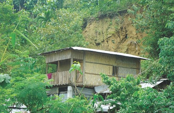 People live in risky homes on the slopes of hills in Bandarban town. Some of the hills show signs of previous landslides. The photos were taken last week. Photo: Star