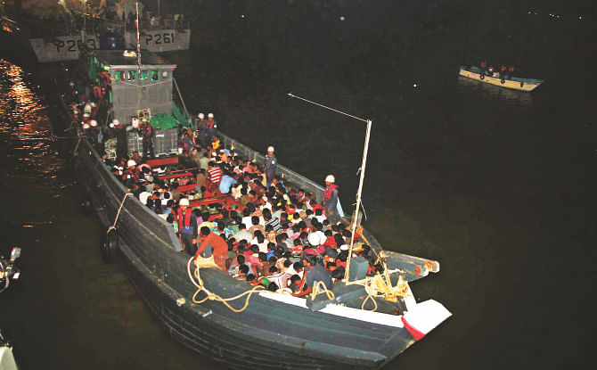 The Bangladeshi and Myanmarese fortune-seekers, who were rescued by Bangladesh Navy from a trawler in the Bay on Monday while going to Malaysia illegally, being drifted to Patenga in Chittagong last night. Photo: Star