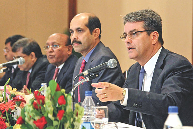 Right, Roberto Azevedo, director general of World Trade Organisation, speaks at a meeting at Sonargaon Hotel in Dhaka yesterday. Commerce Minister Tofail Ahmed and BGMEA President Atiqul Islam are also seen.  Photo: Star 