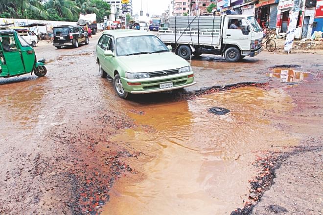 Whatever portion is now left for traffic is also in bad shape, with potholes and an overflow of dirty water from manholes in places. Photo: Palash Khan